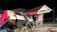 Driver airlifted after van crashes into bank ATM and building