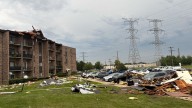 Roof of suburban apartment building torn off by severe storms