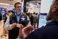 Asian shares are mixed in quiet trading as traders await cues from the Fed