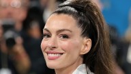 Anne Hathaway takes a tumble in studded heels and a sheer tartan shirt