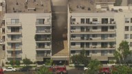 LAFD firefighters working to knock down apartment building fire