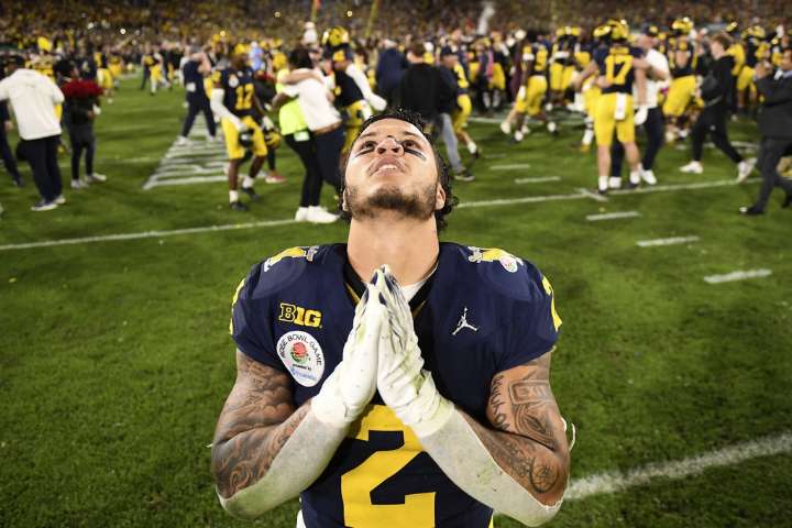 Michigan football fined millions, coach suspended 3 games in sign