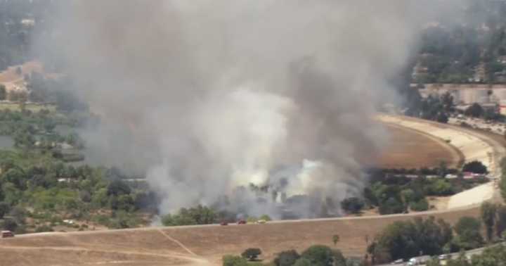 Firefighters battle Sherman Oaks brush fire