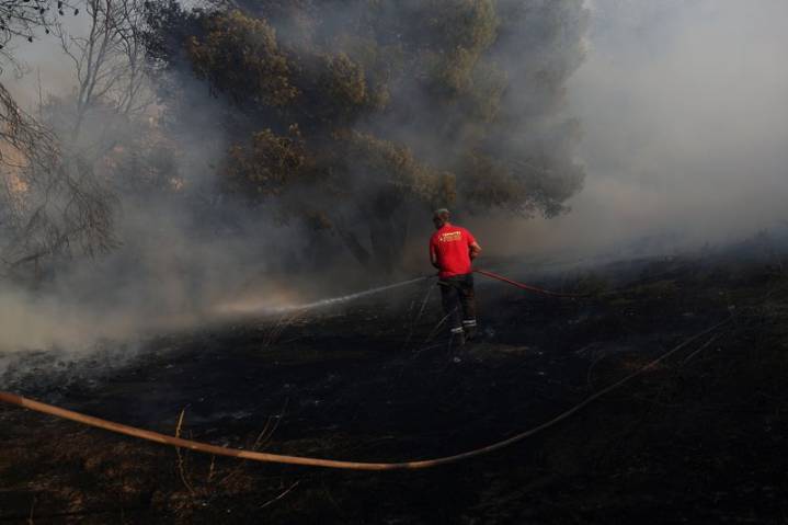 Greece wildfire contained but strong winds prompt evacuations