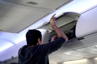 Airline Passenger Removes Man's Shoes from Overhead Cabin, Puts Them on the Floor