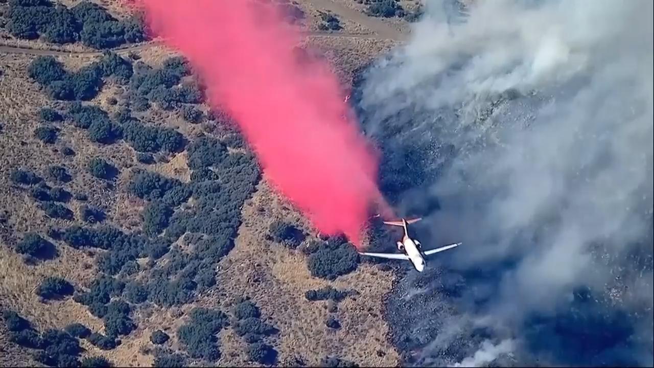 Some residents were ordered to evacuate as fire crews combat a brush fire in Los Angeles County