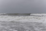 OC beach patrol pulls child, warns public as hurricane drives surf on boardwalk, dunes