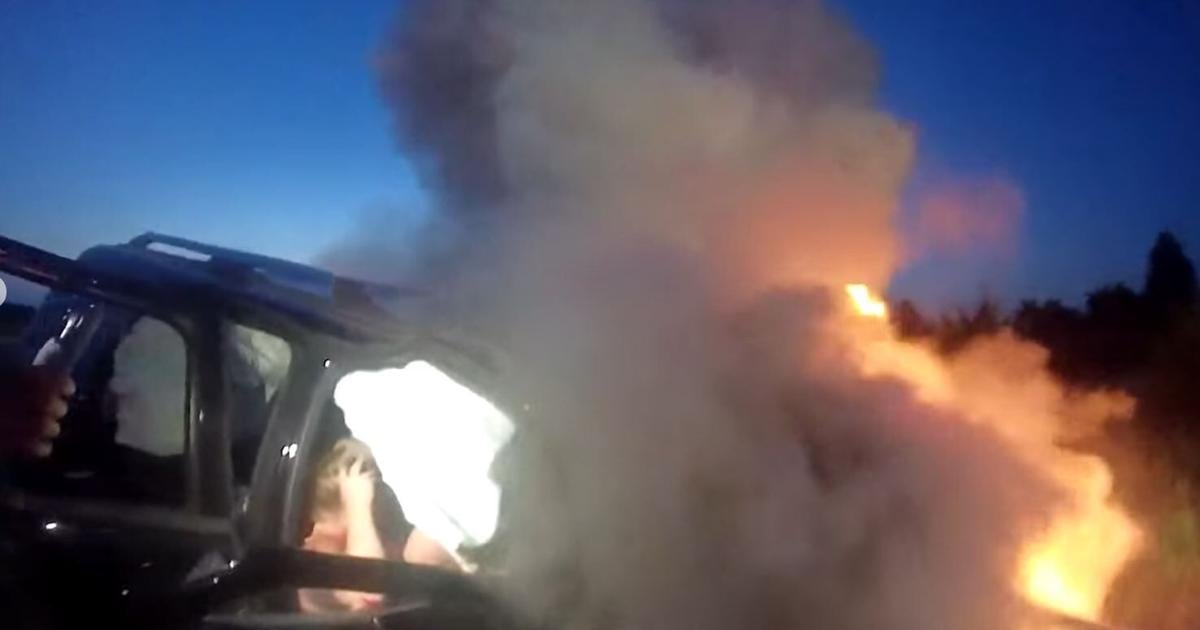 Heroics on the highway as authorities rescue woman from burning car