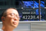 World shares sink after Trump escalates feud with the Federal Reserve