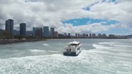Yacht-sized passenger boat runs aground in high surf off Hawaii beach