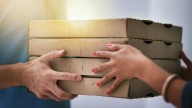 Pizzeria owner offers free food to people eating from dumpsters