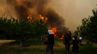 At least 3 dead and thousands displaced as wildfires rage across southern Europe