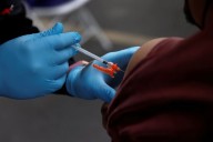US insurers likely to cover updated COVID shots this year, industry sources say