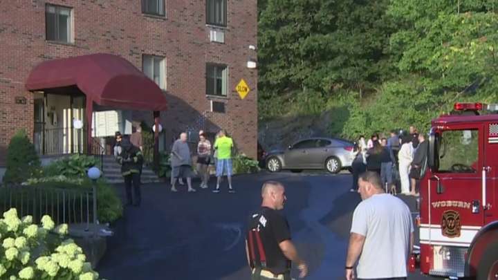Woman taken to hospital following Woburn fire