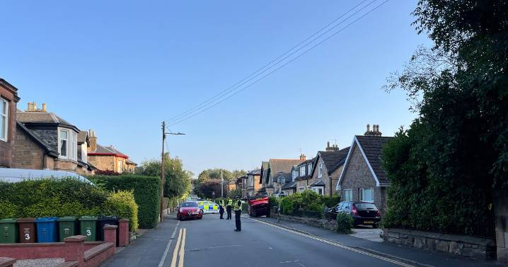 'Freak accident' as car flips onto garden wall on quiet Glasgow street as police close road