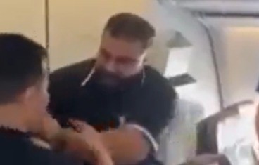Dramatic moment furious plane passenger SLAPS 'thief' after watching him 'steal from bag in overhead cabin'