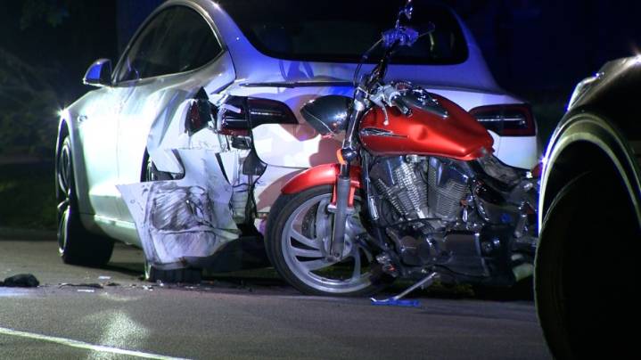 Motorcyclist crashes into back of parked Tesla