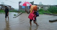 Photos show people fleeing flooding in Kashmir after weeks of intense rain in the region