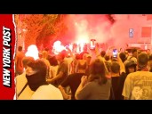 Clashing protesters shoot fireworks during heated standoff in Serbia, causing riot police intervene