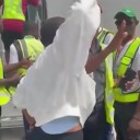Moment plane passenger bundled screaming onto airport bus after punching stewardess & 'refusing to turn off her phone’