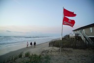 Summer celebrations meet closed beaches and warnings on US East Coast due to Hurricane Erin