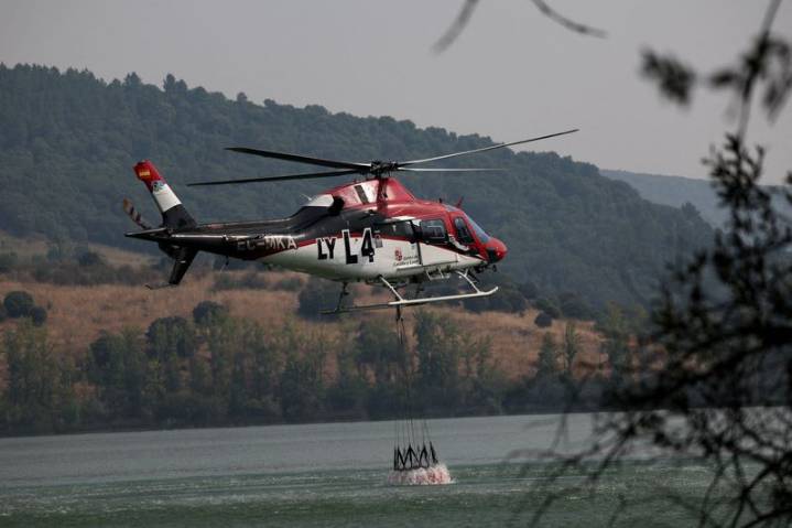 Volunteer firefighter dies as wildfires rage across heat