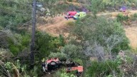 Two firefighters dead & three fighting for life after truck skids off road & plunges into ravine while on emergency call