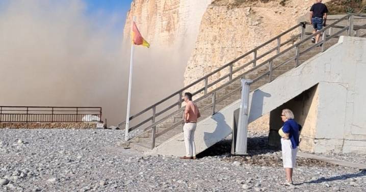 Heart-stopping moment cliff face caves in as horrified tourists watch on
