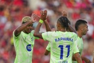 Raphinha and Yamal score as Barcelona starts La Liga title defense beating 9