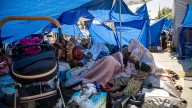 Migrants 'urinated on' after hundreds protest & sleep under tarpaulins outside Paris' iconic town hall