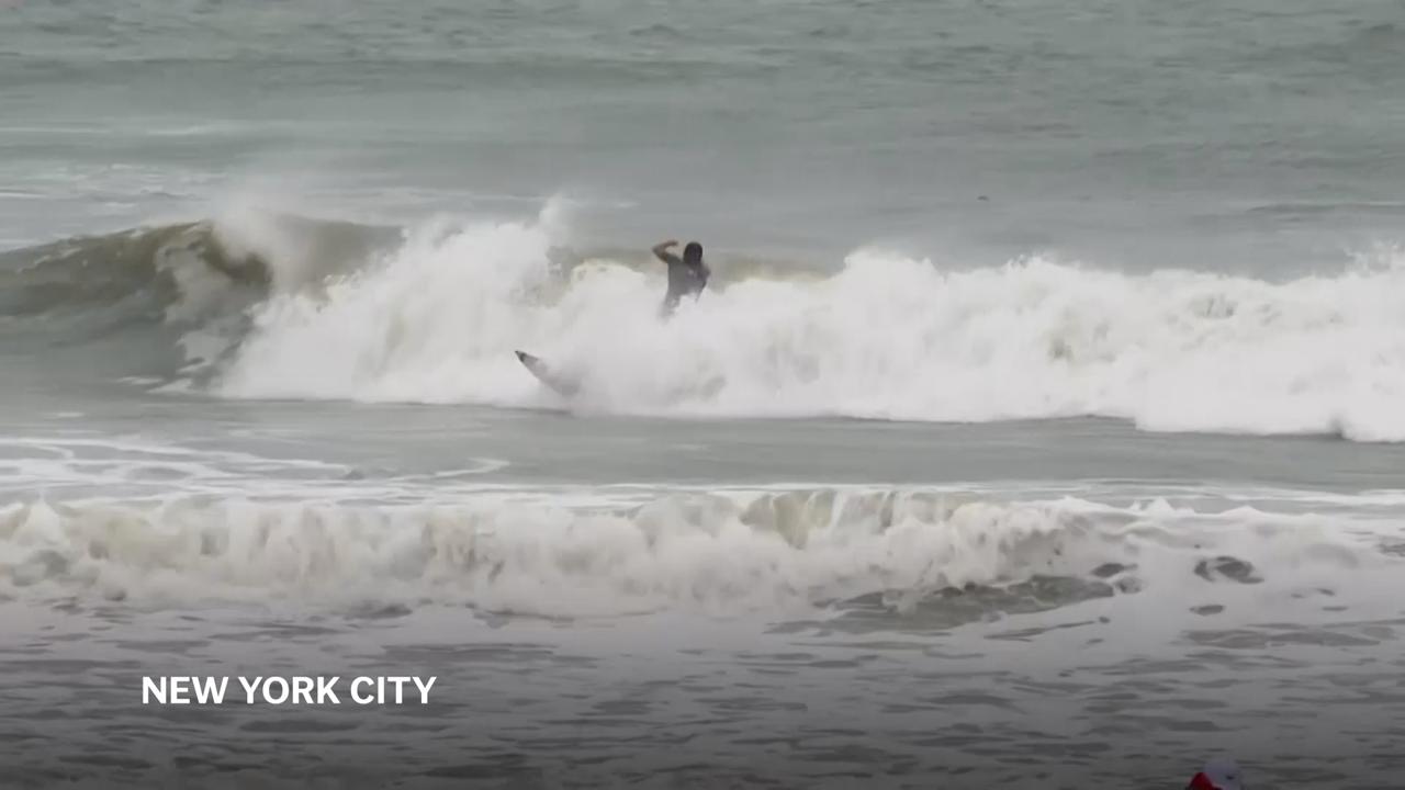 Rockaway Beach surfers defy warnings and brave Hurricane Erin’s rough seas