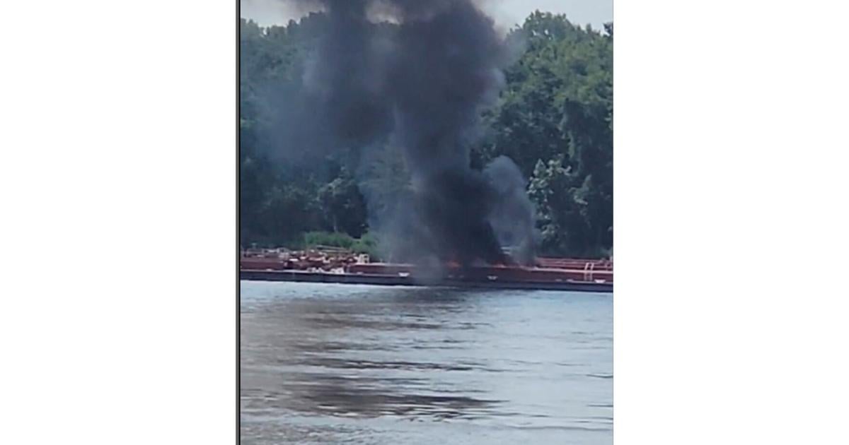 Two die when helicopter strikes powerlines and crashes into a barge on the Mississippi River
