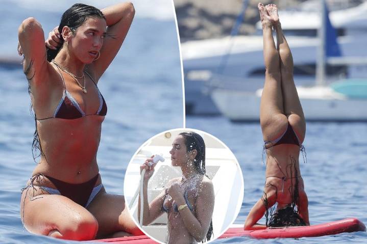 Dua Lipa flaunts her abs during paddleboard yoga in Ibiza