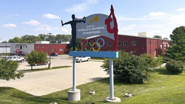 Years after abuse reports, ex-coach at renowned US gymnastics academy is arrested by FBI