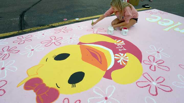 Monroe High parking lot gets splash of color from seniors