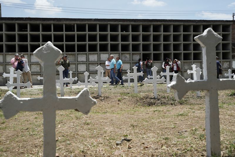 Former Colombian rebels and soldiers work together to exhume remains, give families closure