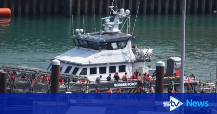 First small boat migrants detained under 'one