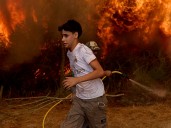 Spain battles record wildfires even as the end of a heat wave brings lower temperatures