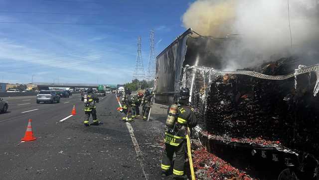 Trailer hauling strawberries catches fire on I