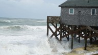 Hurricane Erin stirs up strong winds and floods part of a NC highway as it slowly moves out to sea