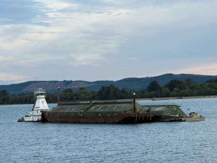 Grain barge takes on water in Columbia River before being righted near Kalama