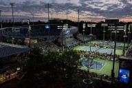 At the US Open, tennis stars shine under dark sky