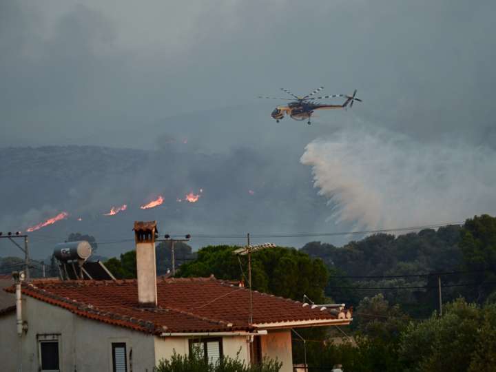 At least one killed as firefighters battle Greece blaze for second day