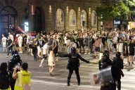 Dozens detained as opponents and supporters of Serbian government clash during protests