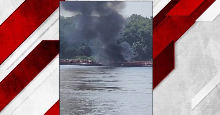 Two die when helicopter strikes powerlines and crashes into a barge on the Mississippi River