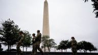 National Guard troops in Washington, DC, begin carrying weapons