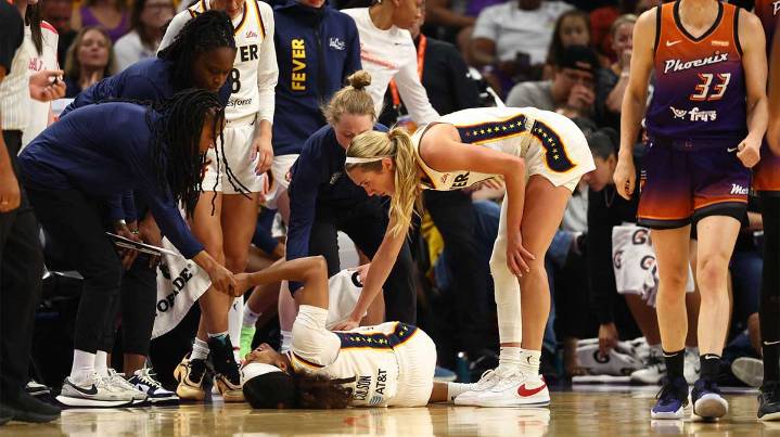 Fever’s Sydney Colson helped off the court after apparent injury vs. Mercury
