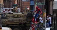 Moment Spider-Man stunt double races through Glasgow streets on military vehicle