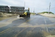 Hurricane Erin stirs up strong winds and floods part of a NC highway as it slowly moves out to sea