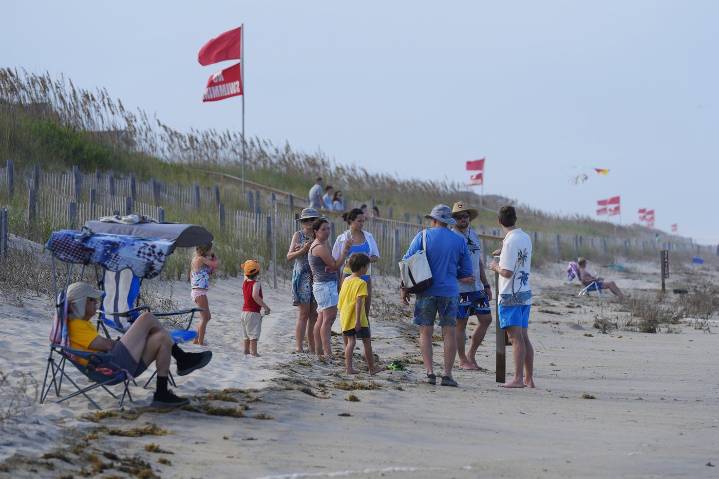 Summer celebrations deal with closed beaches and warnings on US East Coast due to Hurricane Erin